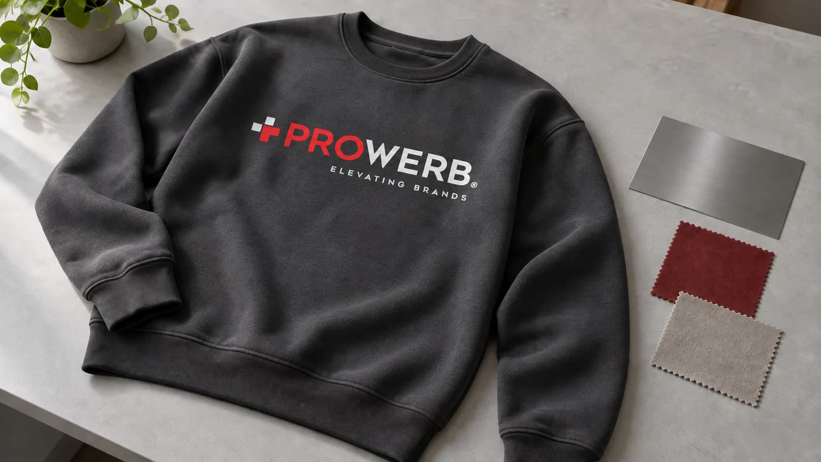 Sweatshirt mit PROWERB-Logo neben Stoff- und Metallmustern.