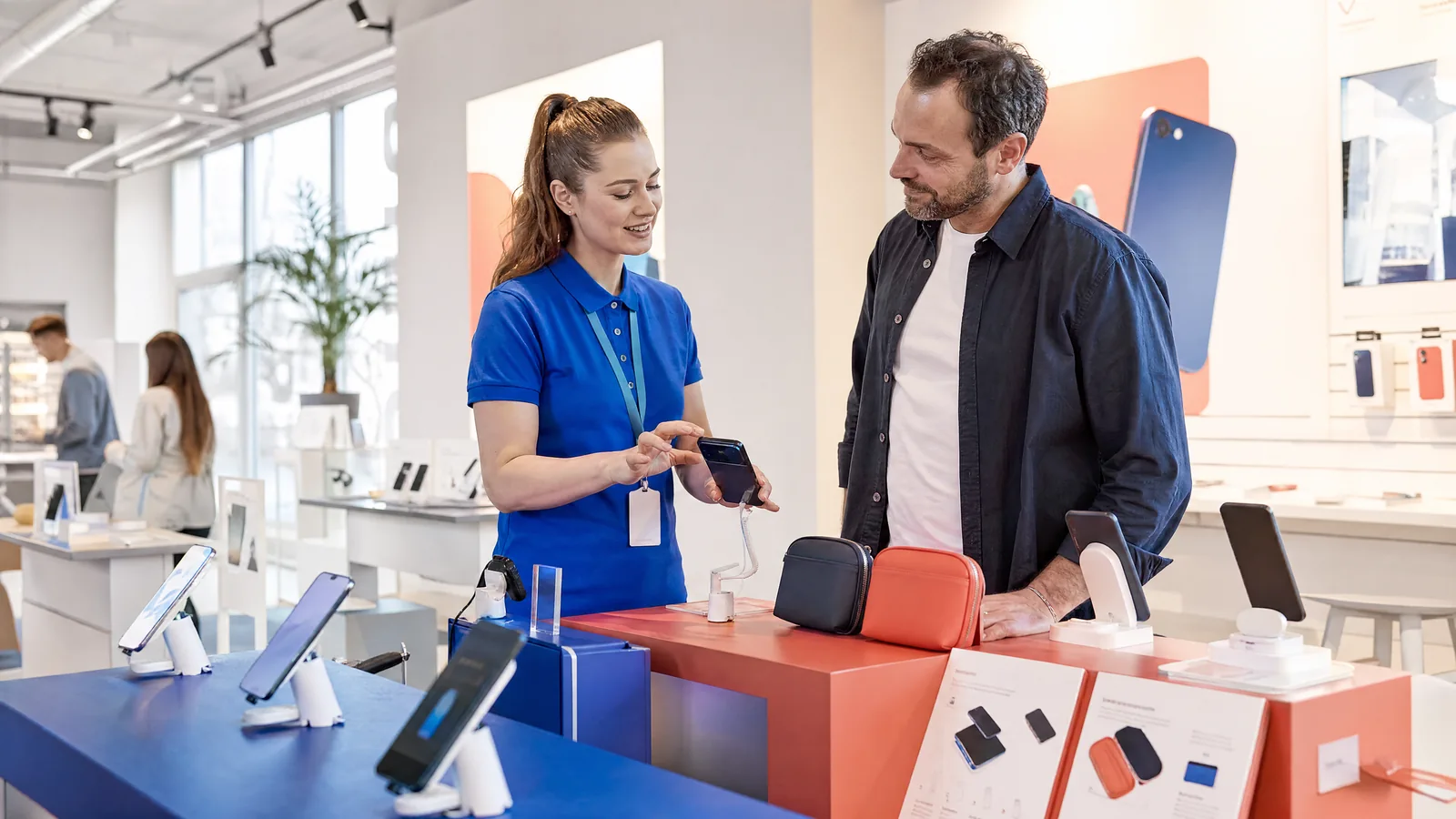 Product advice and campaign materials at a telecom pop-up.